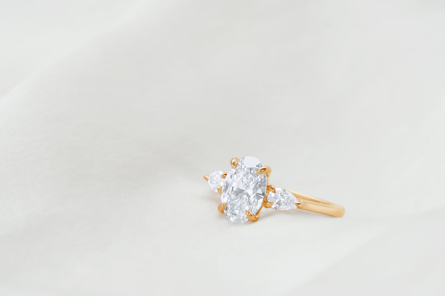 Oval and Pear Diamond Three Stone Diamond Engagement Ring