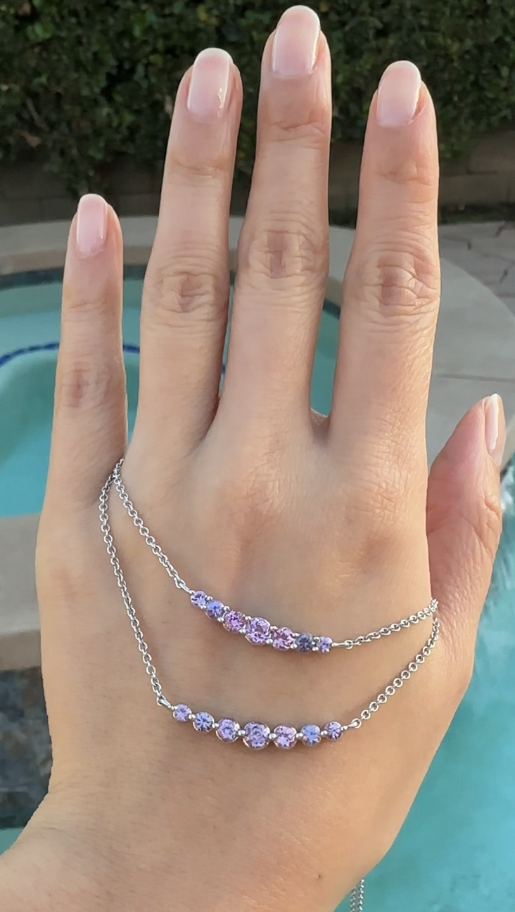 On Hand: Violet Rose Sapphire Smile Crescent Necklace set with Unheated Violet Rose Sapphires from Madagascar, in 18K White Gold, Single Prong and Double Prong Style.